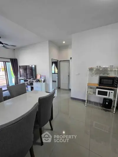 Modern open-plan living and dining area with sleek furniture and natural light