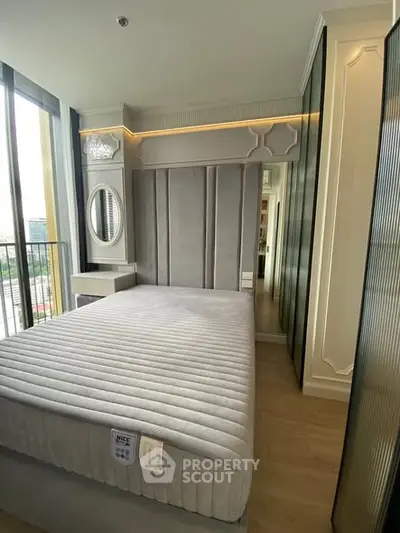 Luxurious bedroom with modern design and large windows offering city views