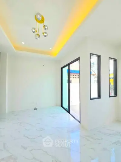 Modern living room with marble flooring and stylish lighting in a bright, open space.