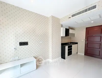 Modern compact kitchen with sleek cabinetry and stylish wallpaper