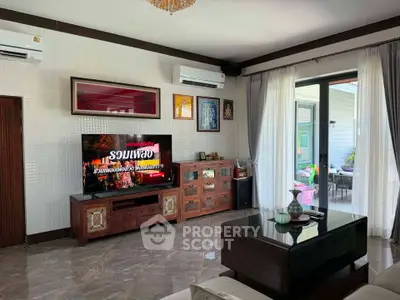 Spacious living room with modern decor and large sliding glass doors leading to a patio.