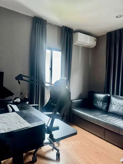 Modern living room with sleek furniture and air conditioning