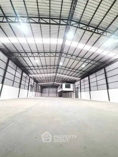 Spacious industrial warehouse with high ceilings and ample storage space.