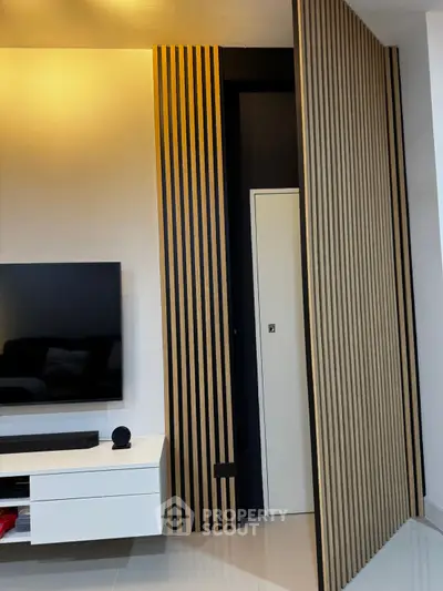 Modern living room with sleek TV unit and stylish wooden paneling
