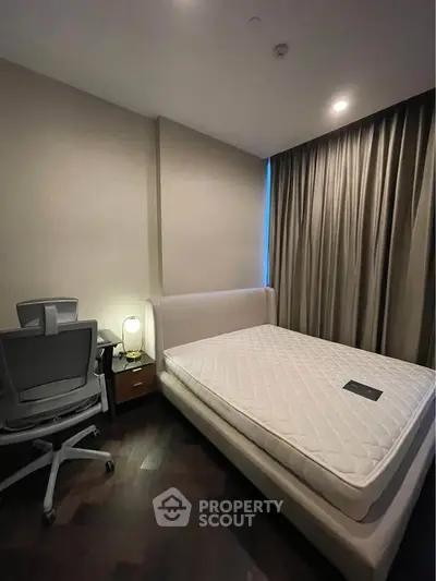 Modern bedroom with sleek furniture and ambient lighting, perfect for a cozy retreat.