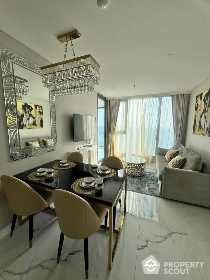 Luxurious modern living room with elegant dining area and stunning ocean view.