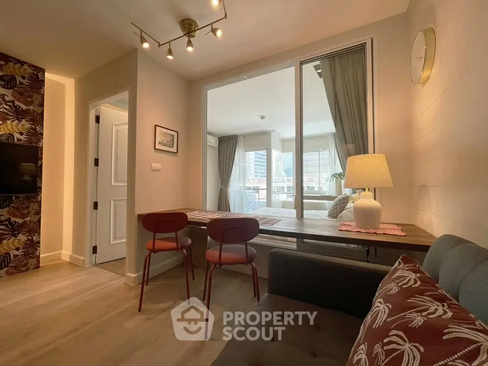 Modern living room with stylish decor and large windows offering natural light.