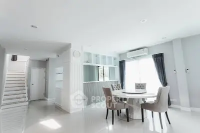 Elegant modern dining area with natural light and stylish furniture in a spacious home interior.