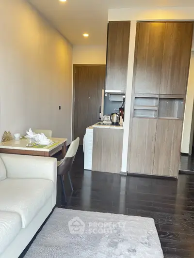 Modern living room with compact kitchen and elegant dining area