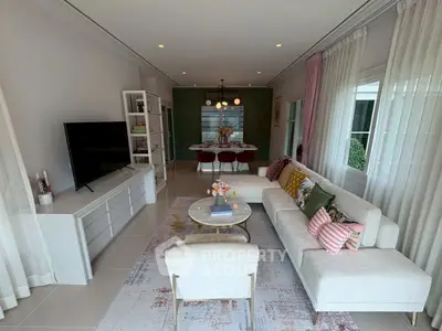 Stylish modern living room with elegant decor and open dining area