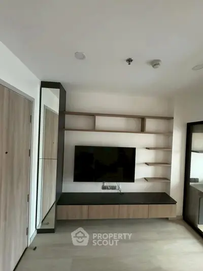 Modern living room with sleek TV unit and open shelving