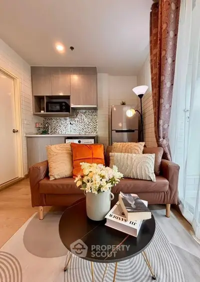 Chic modern living room with cozy sofa and stylish kitchen in open layout apartment.