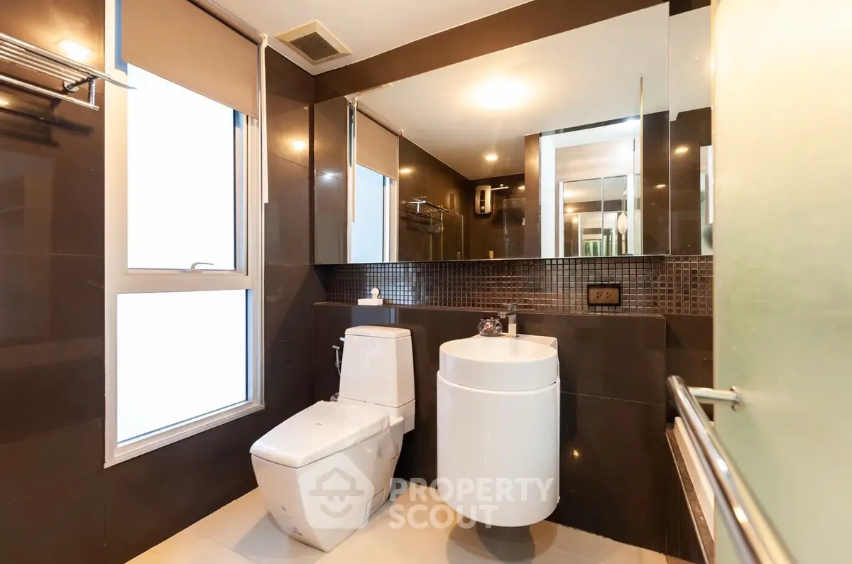 Modern bathroom with sleek fixtures and large mirror
