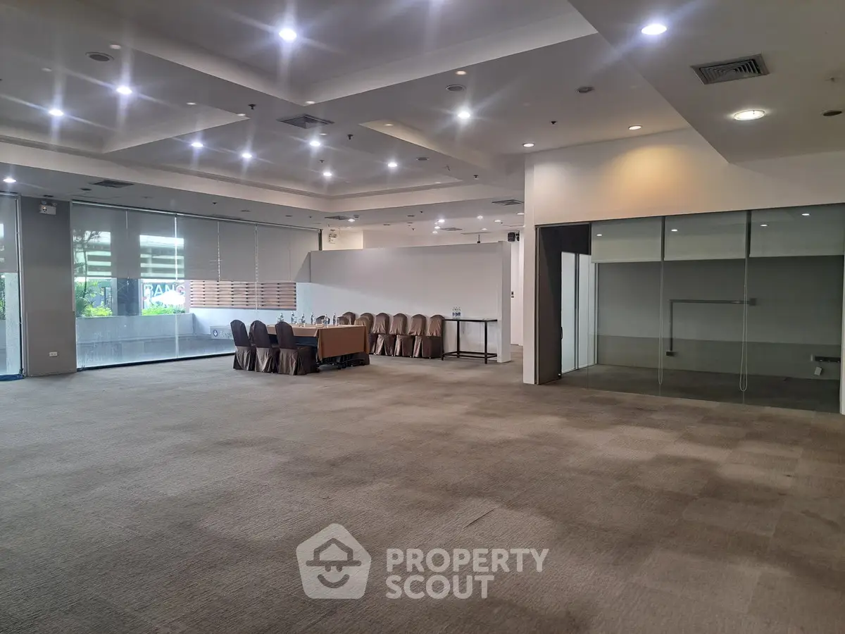 Spacious conference room with modern lighting and large windows