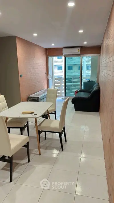 Modern living room with balcony access and stylish furniture