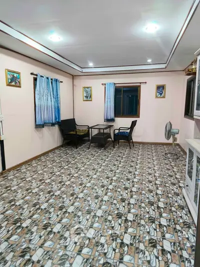 Spacious living room with unique tiled flooring and cozy seating area.