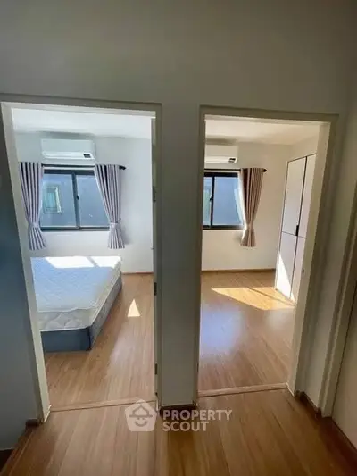 Spacious dual-bedroom layout with natural light and modern flooring.