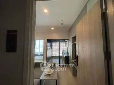 Modern apartment interior with open living and dining area, featuring sleek design and natural light.