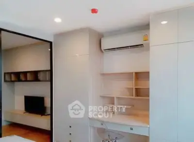 Modern study area with built-in desk and air conditioning in a sleek apartment interior.