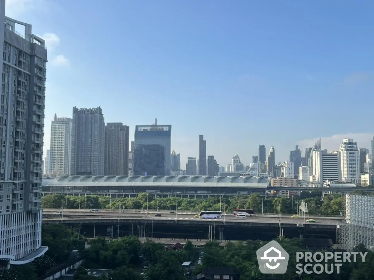 Stunning cityscape view from high-rise apartment balcony with lush greenery and modern skyline.