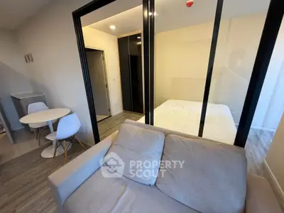 Modern studio apartment with glass partition and cozy furnishings