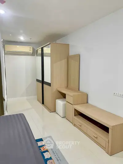 Modern bedroom with sleek furniture and air conditioning in a stylish apartment.