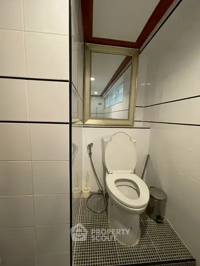 Modern bathroom with sleek white tiles and contemporary fixtures
