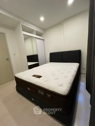 Modern bedroom with plush mattress and built-in closet, perfect for restful nights.