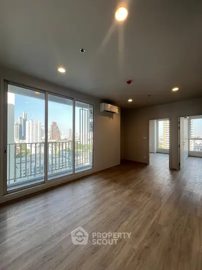 Spacious modern apartment with city view and wooden flooring