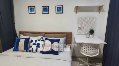 Cozy bedroom with modern decor and compact study area