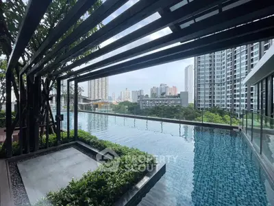 Luxurious rooftop pool with stunning city skyline views in modern high-rise building.