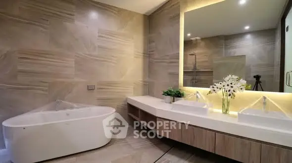Luxurious modern bathroom with elegant bathtub and dual sinks