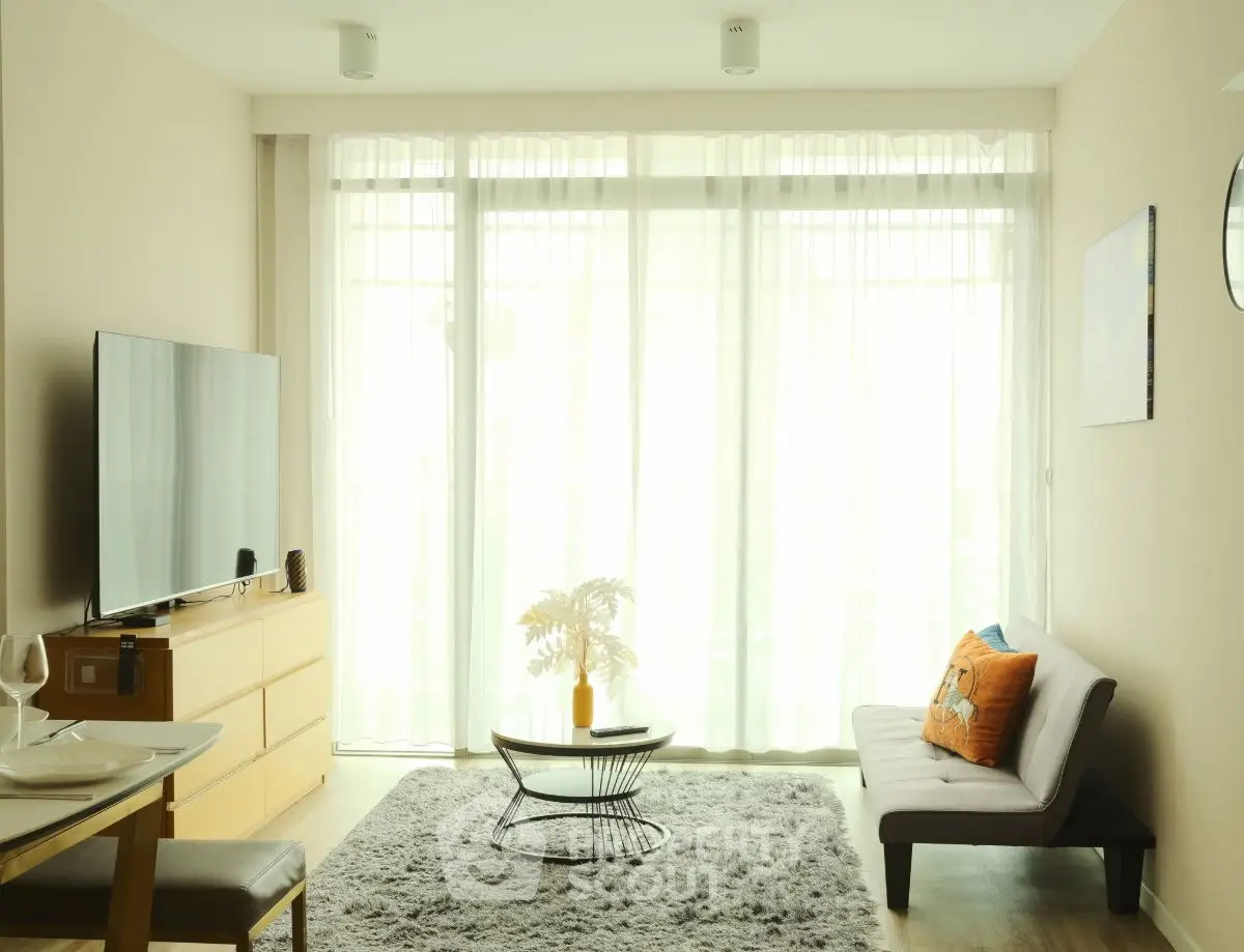 Bright and modern living room with large windows and stylish decor