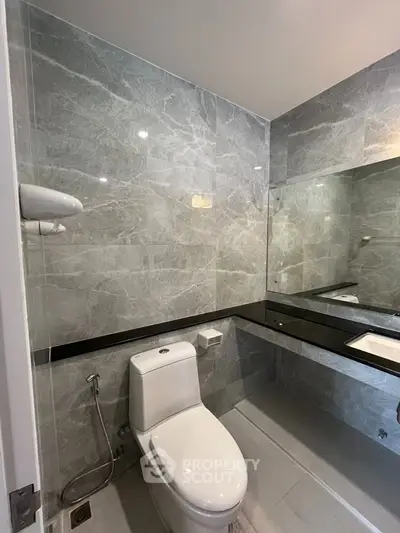 Modern bathroom with sleek marble tiles and contemporary fixtures