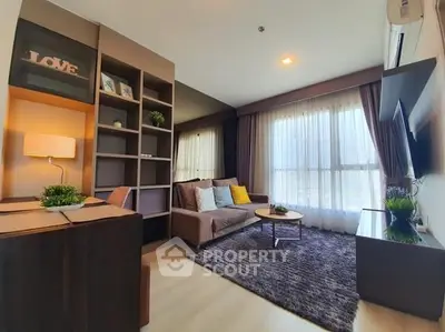 Modern living room with cozy sofa and large window, featuring stylish decor and ample natural light.