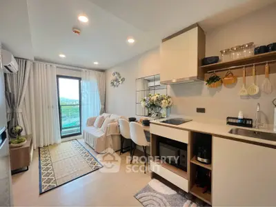 Modern open-layout kitchen and living area with balcony view
