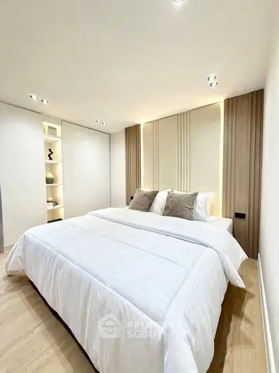 Modern bedroom with elegant design and cozy ambiance, featuring a plush bed and stylish decor.