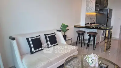 Modern open-layout living room with stylish kitchen and cozy seating area.