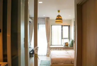 Cozy bedroom with natural light and modern decor in a stylish apartment.