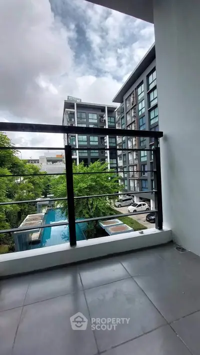 Modern apartment balcony with city view and pool, perfect for urban living.