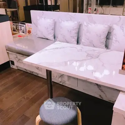 Stylish modern dining nook with marble table and cushioned seating