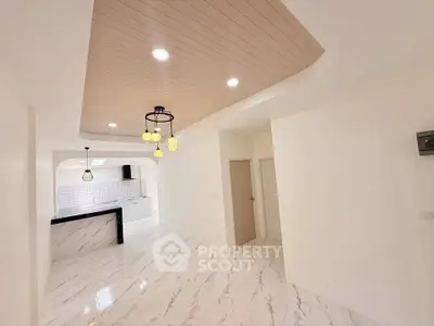 Spacious modern kitchen with elegant marble flooring and stylish ceiling lights