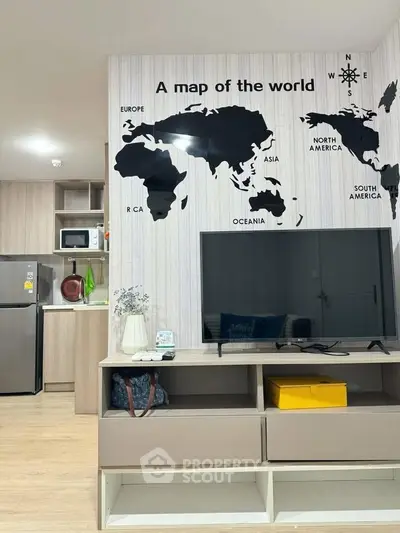 Modern living room with world map wall art, sleek TV stand, and open kitchen view.