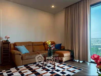 Stylish living room with leather sofa and city view balcony, perfect for modern urban living.