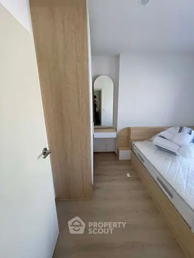 Modern minimalist bedroom with wooden furniture and cozy ambiance