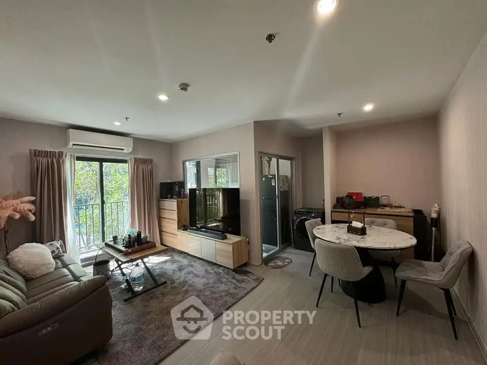 Modern living room with balcony and dining area in stylish apartment