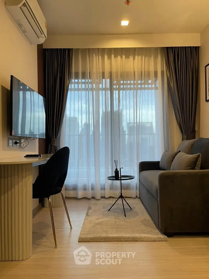 Modern living room with city view, stylish sofa, and sleek TV setup.