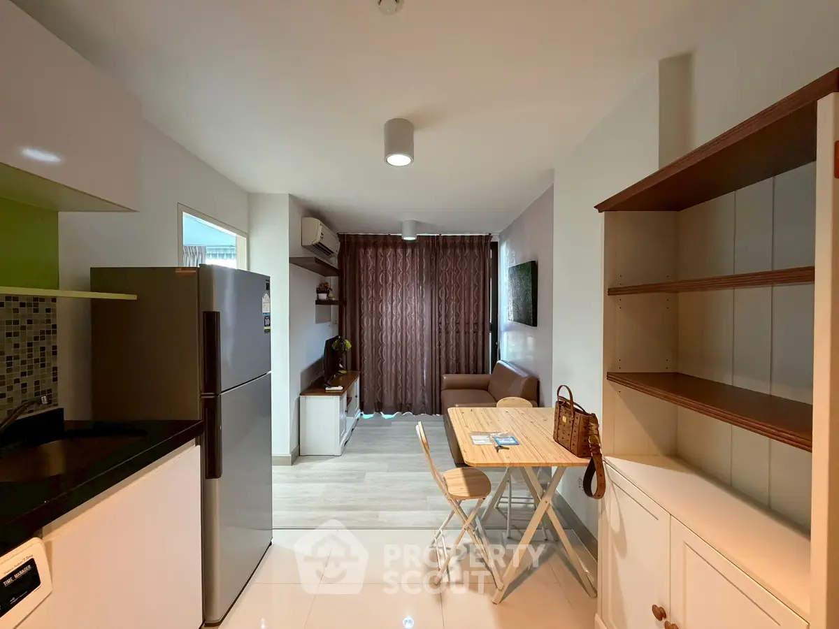 Modern open-layout kitchen and living area with stylish furniture and natural light