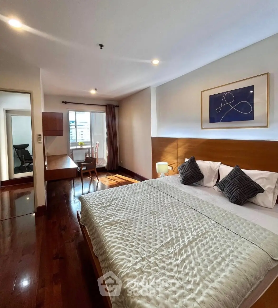 Spacious bedroom with elegant decor and natural light in modern apartment