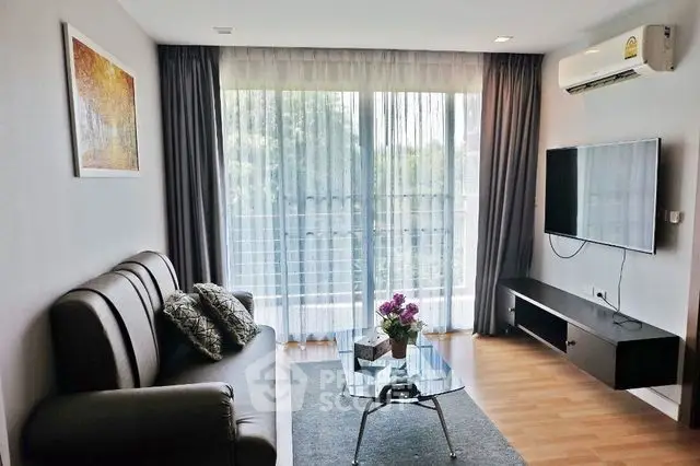 Modern living room with large window, stylish sofa, and wall-mounted TV